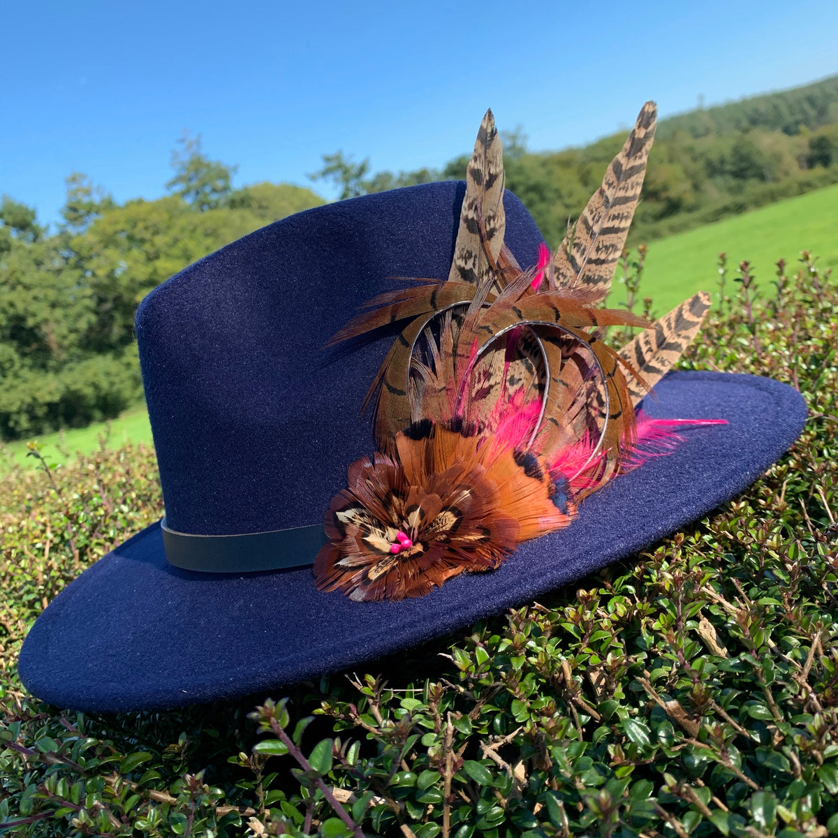 Navy felt Fedora, embellishe with natural game bird feathers All