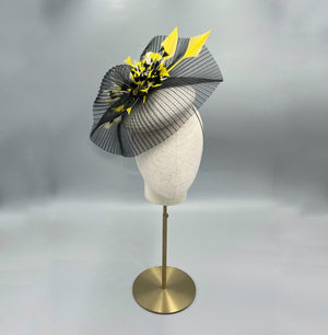 Handmade black and yellow fascinator with sculpted feathers and parasisal base on elastic, ideal for weddings or race day fashion.
