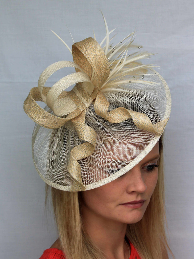 Etta - The base of the fascinator is created from a single layer of sinamay, each one is hand sewn to a gather and finished with a sinamay binding. Each one is hand crafted so the size may alter slightly.