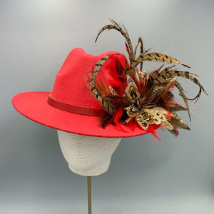 Red fedora hand embellished with natural game bird feathers